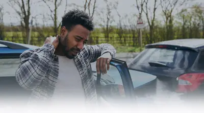 Man examines neck pain after car accident