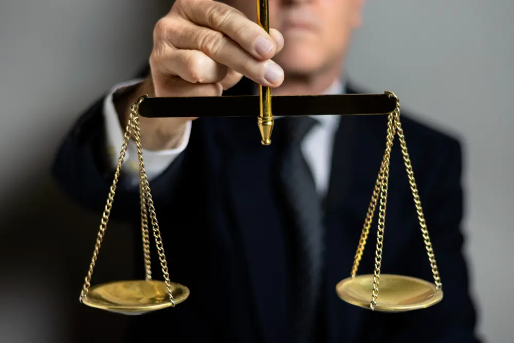 Person holding justice scales, legal concept.