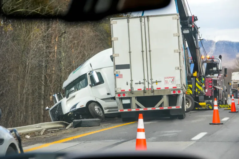 Semi-truck accident being towed on highway