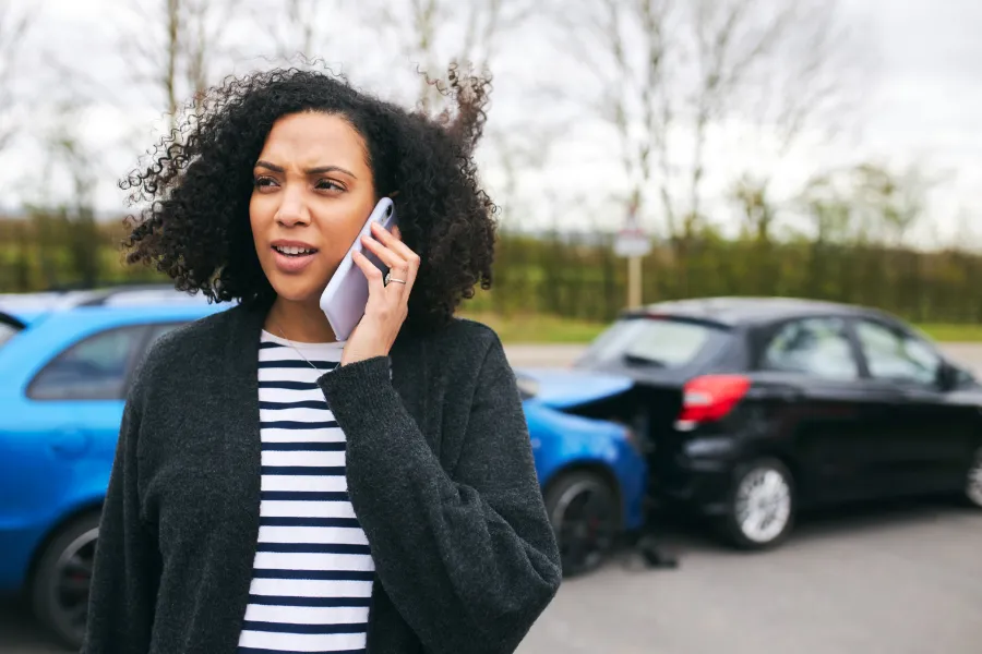 Woman on phone after car accident