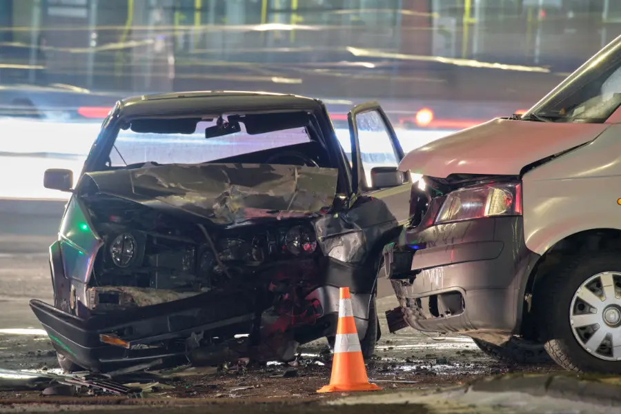 Two cars in a severe collision at night.
